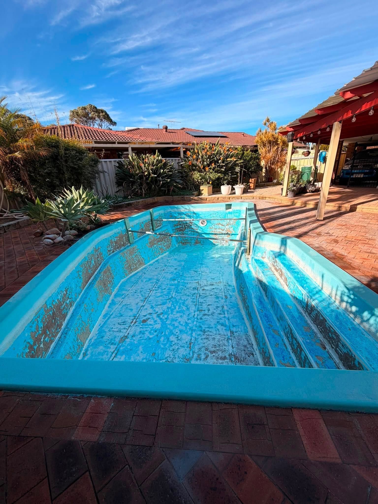 During image of a swimming pool which requires resurfacing.