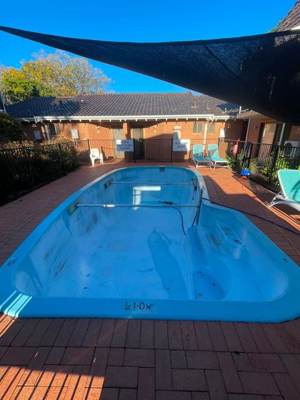 Before image of a swimming pool which requires resurfacing.