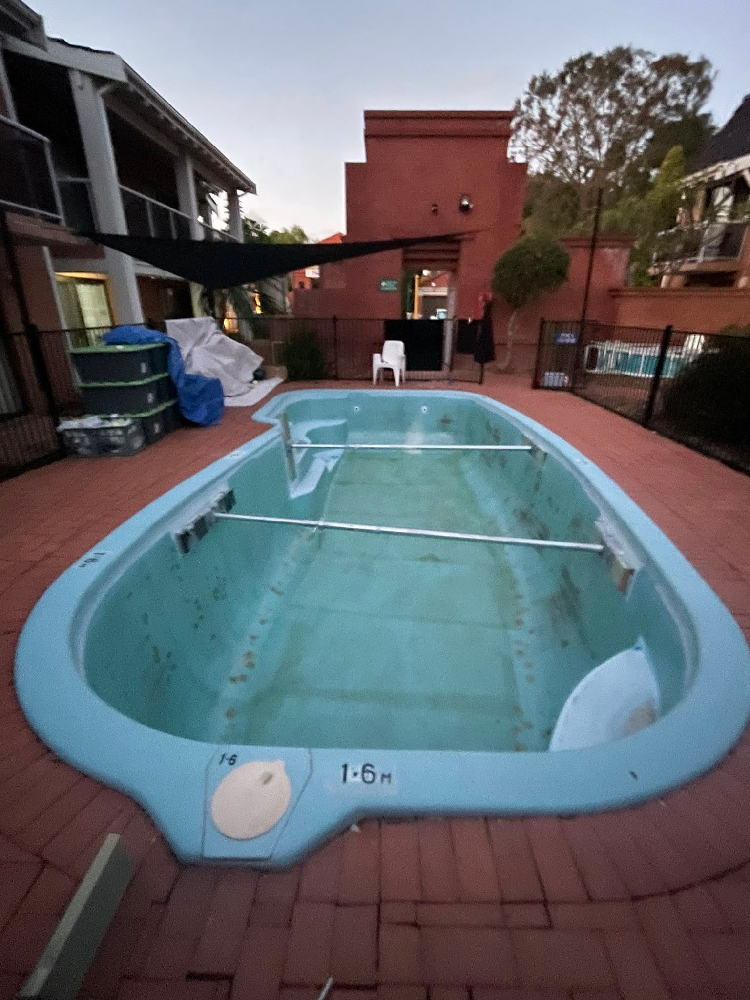 During image of a swimming pool which requires resurfacing.