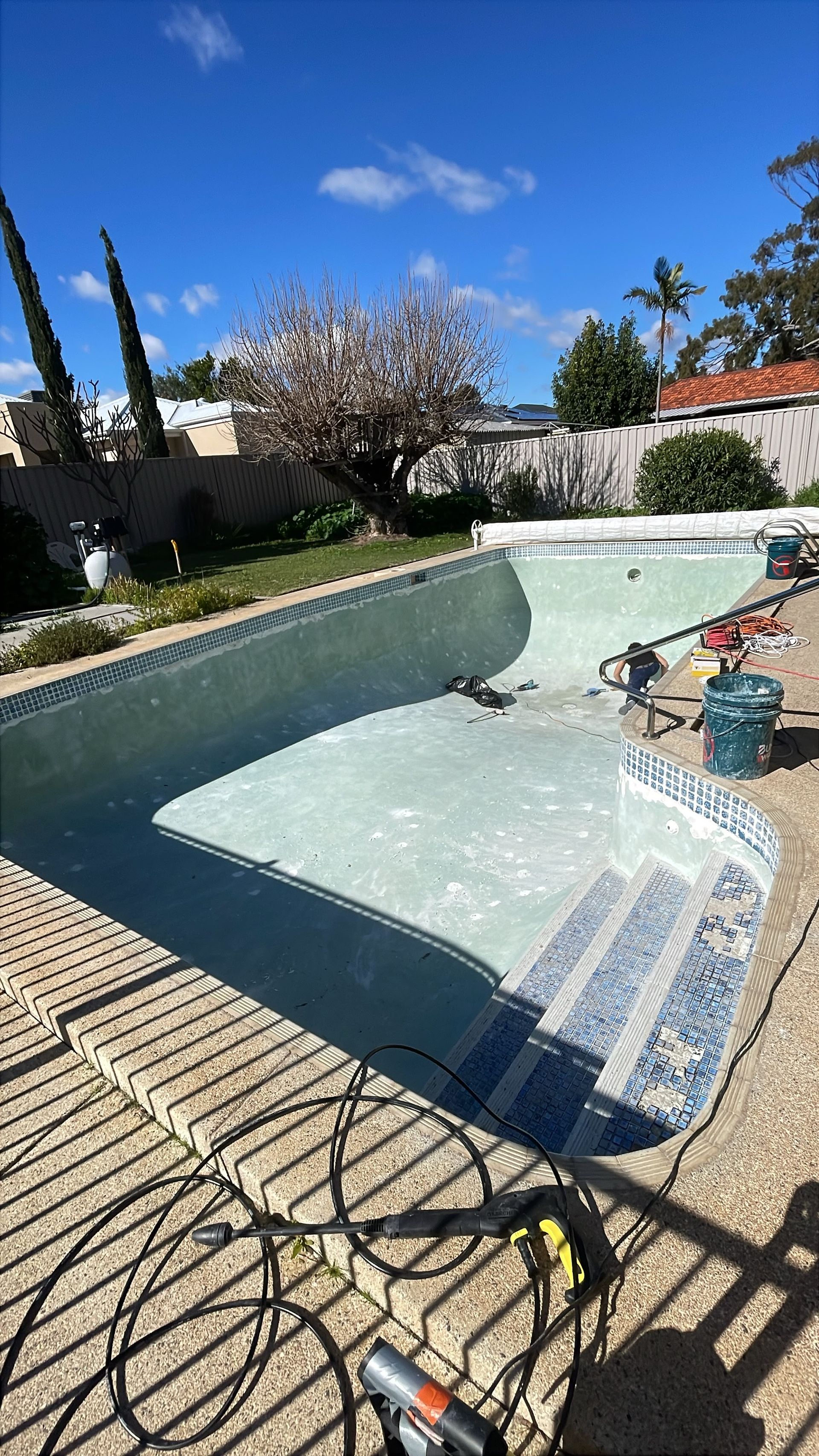 Before image of a swimming pool which requires resurfacing.