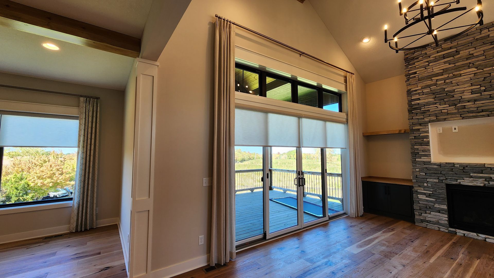Solar Shield Roller Shades with side panel draperies and custom drapery hardware