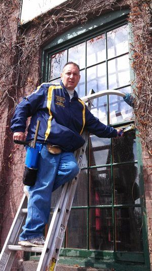 Owner On Side Ladder Cleaning Outside Windows — Hadley, MA — Family Window Cleaning & Property Maintenance