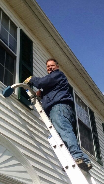 FWC On A Ladder Smiling — Hadley, MA — Family Window Cleaning & Property Maintenance