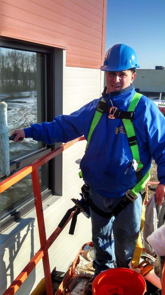 Owner On Harness Cleaning Windows — Hadley, MA — Family Window Cleaning & Property Maintenance