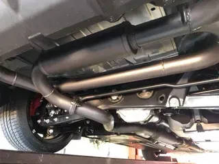 A Close Up of the Underside of a Car With Exhaust Pipes — Ace Exhaust Centre in Berserker, QLD