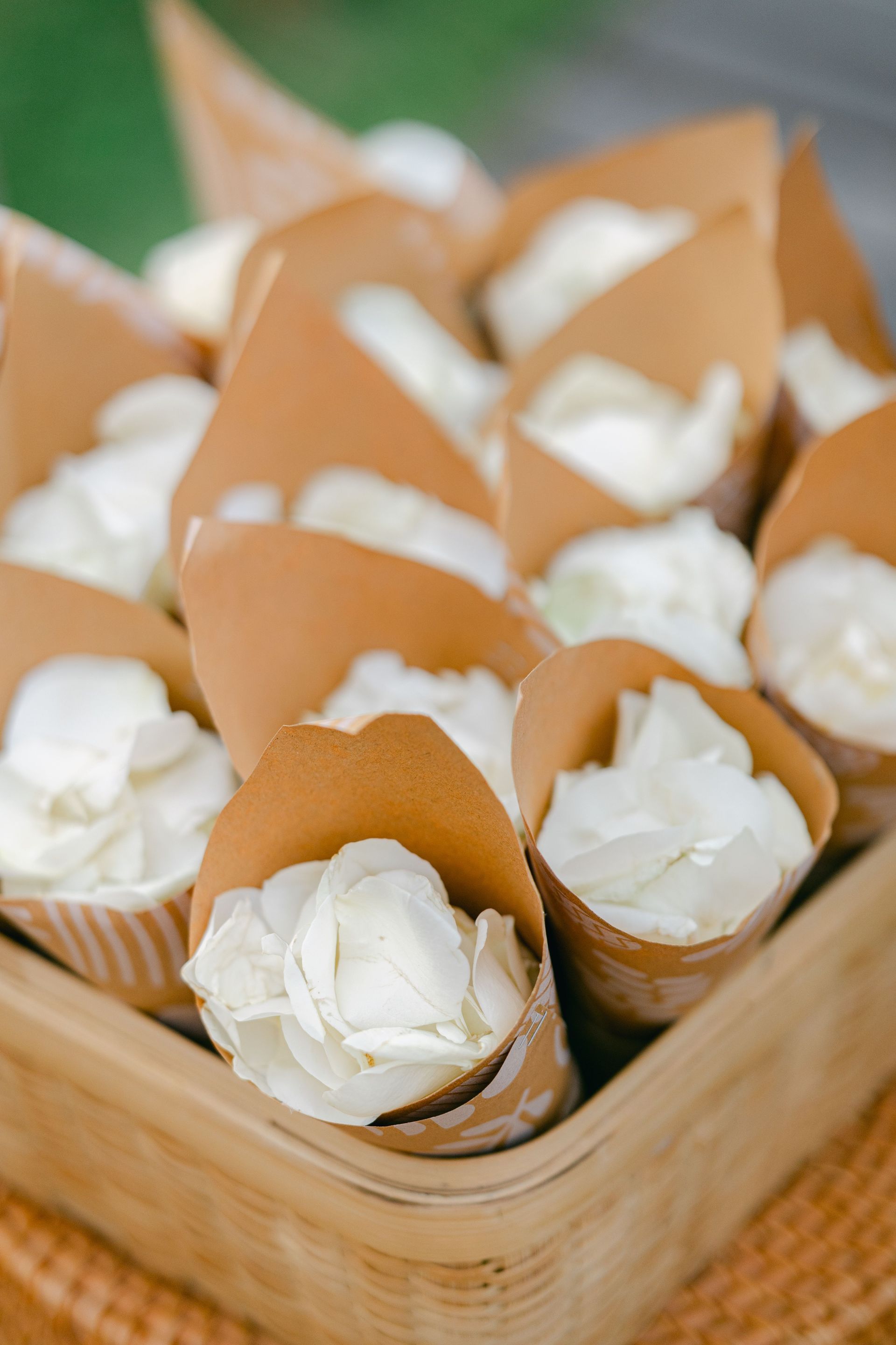 Basket of white flowers wrapped in brown paper cones