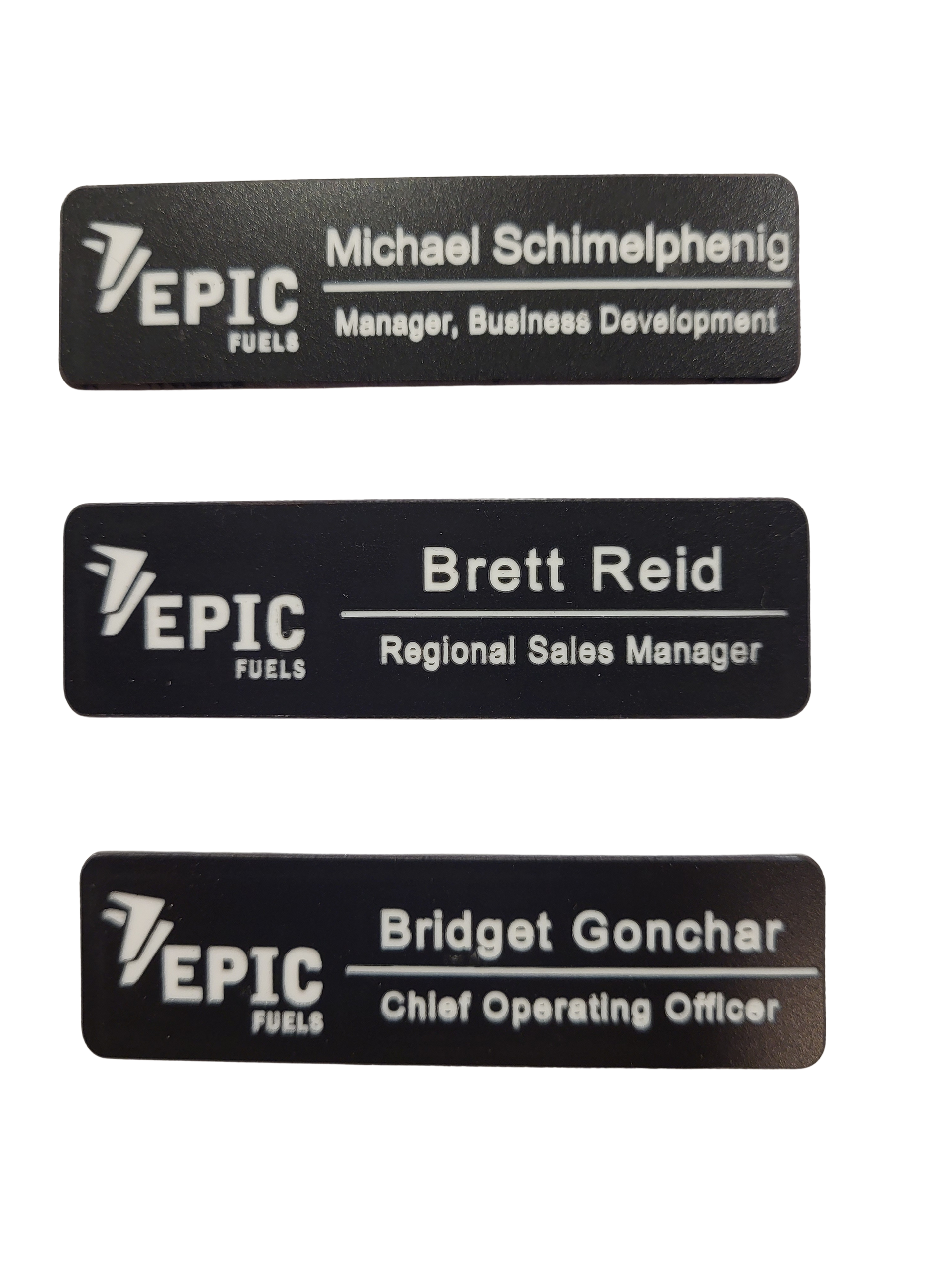 Three black rectangular name tags for Epic Fuels, each featuring the company logo, a name, and a job title.