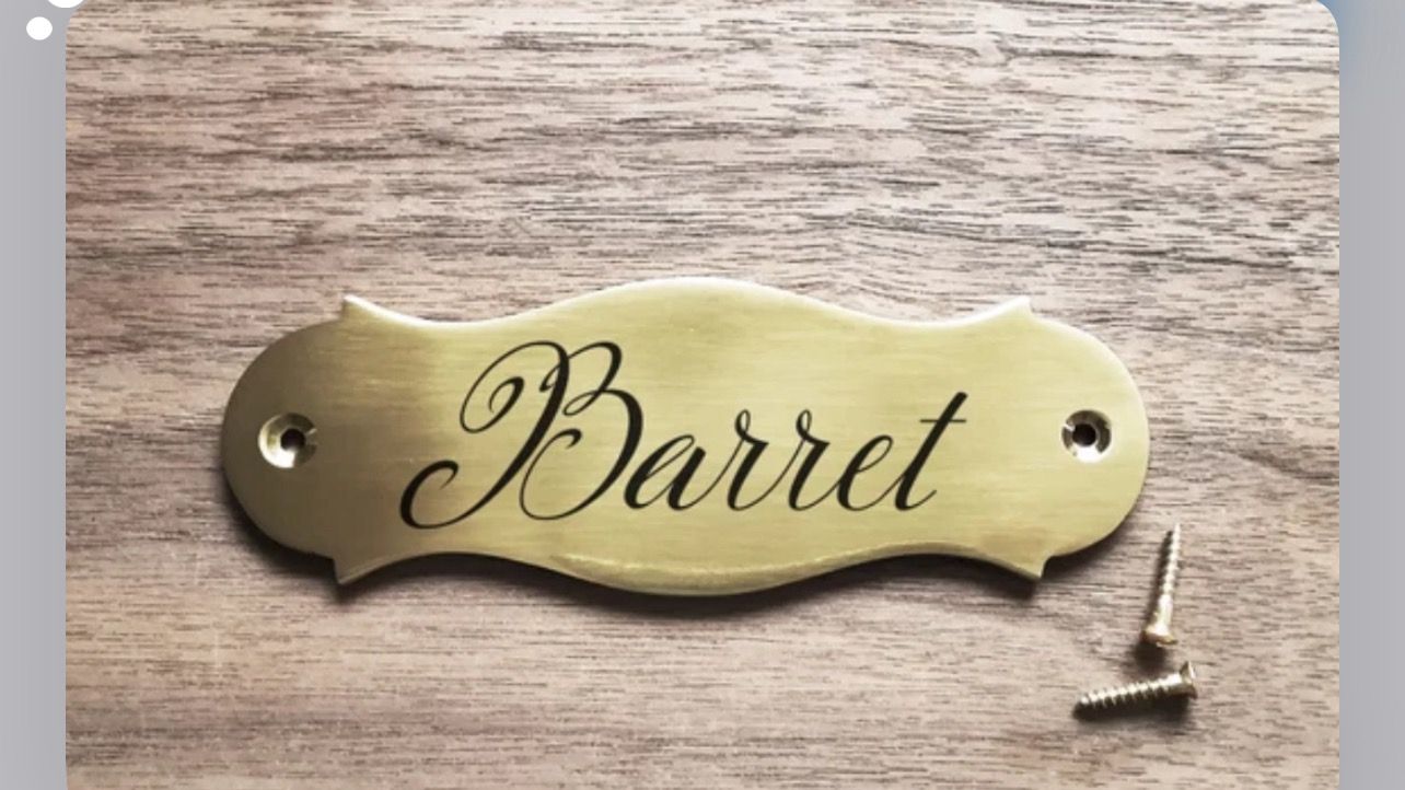 A brass nameplate with the word 