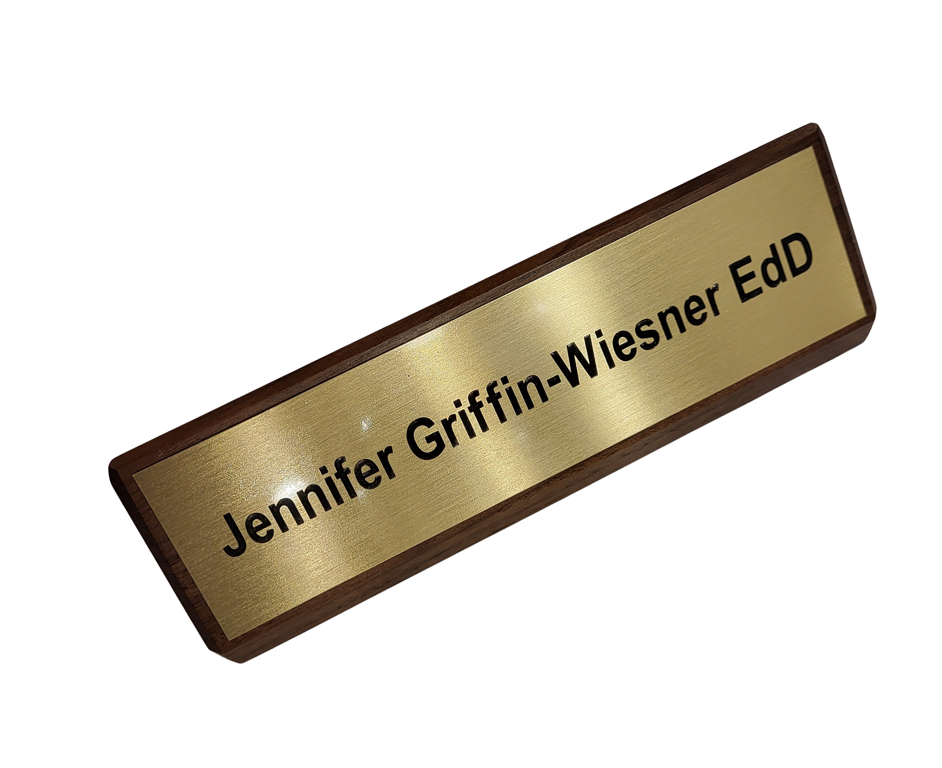 A gold-colored nameplate with a dark border, engraved with the text 