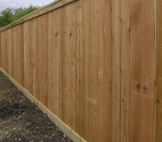 New wooden privacy fence along a yard edge