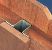 Close-up of a wooden joint with a square metal connector in the center