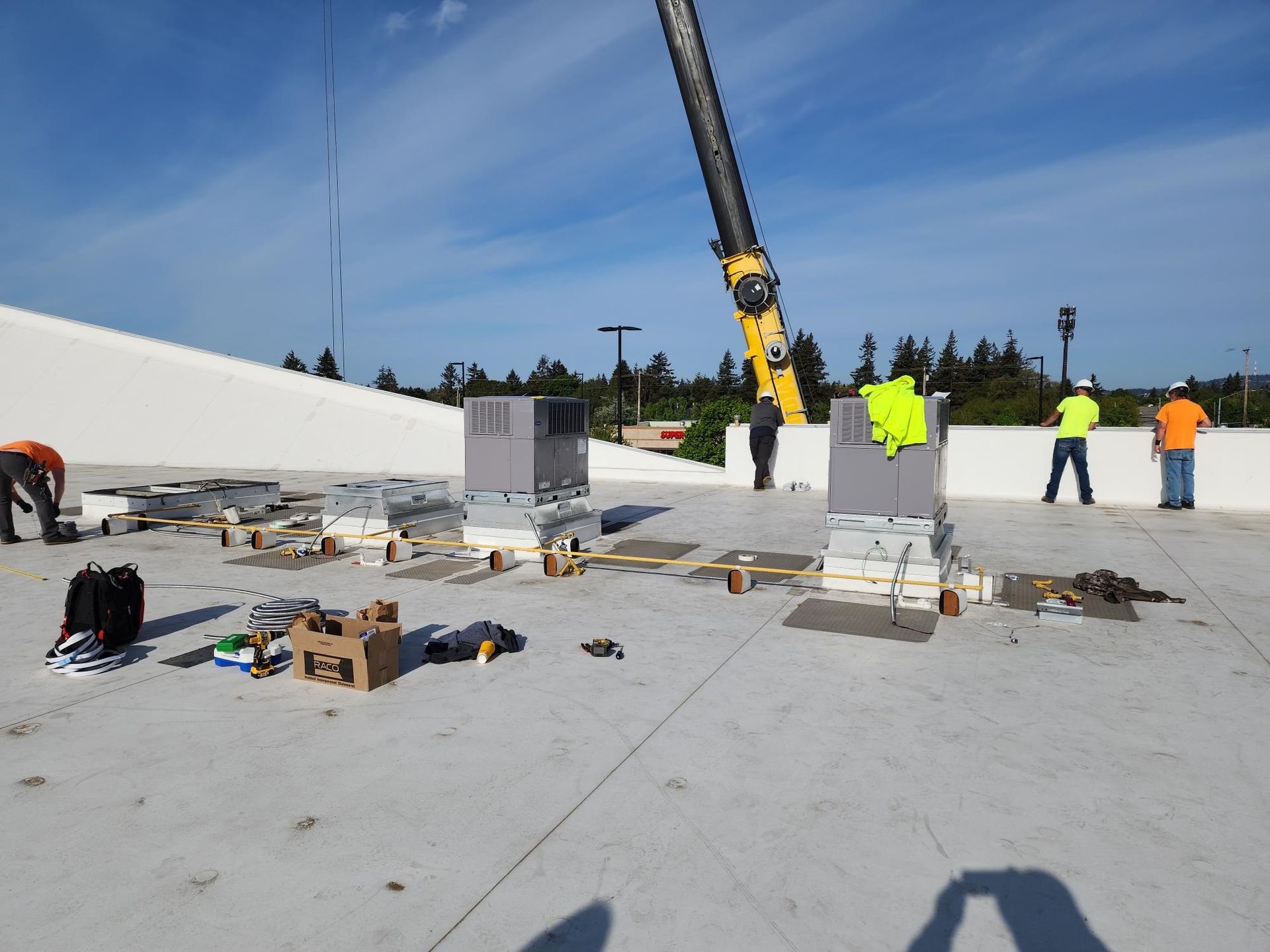 Construction workers are working on the roof of a building