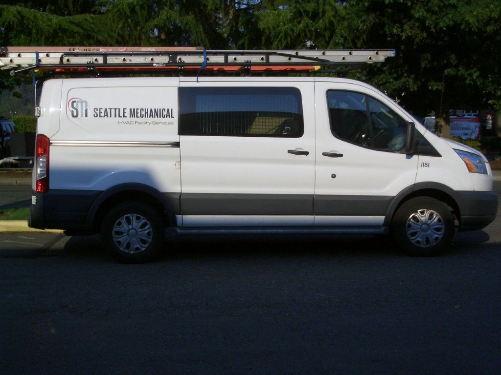 A white van with the word seattle on the side
