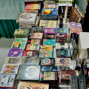 Colorful stacks of trading card boxes displayed on a table at a market stall
