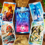 Shaman Tarot deck with colorful cards arranged around a central blue card on a wooden surface