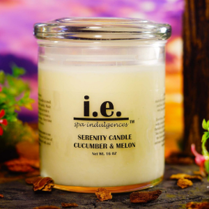 Glass candle labeled “i.e.” Serenity Candle Cucumber & Melon on a colorful floral background