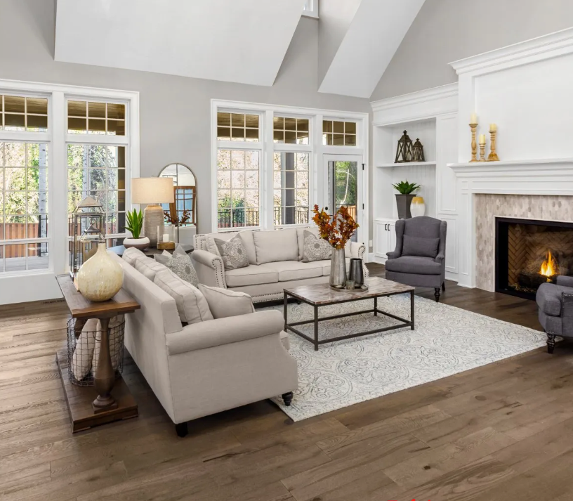 A living room with a couch , chairs , coffee table and fireplace.