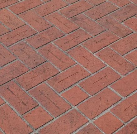 Red brick herringbone pattern paving stones.