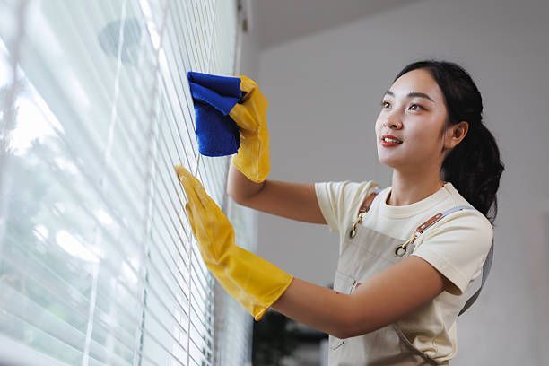 Textured golden horizontal blinds with uniform slats and subtle light and shadow patterns.