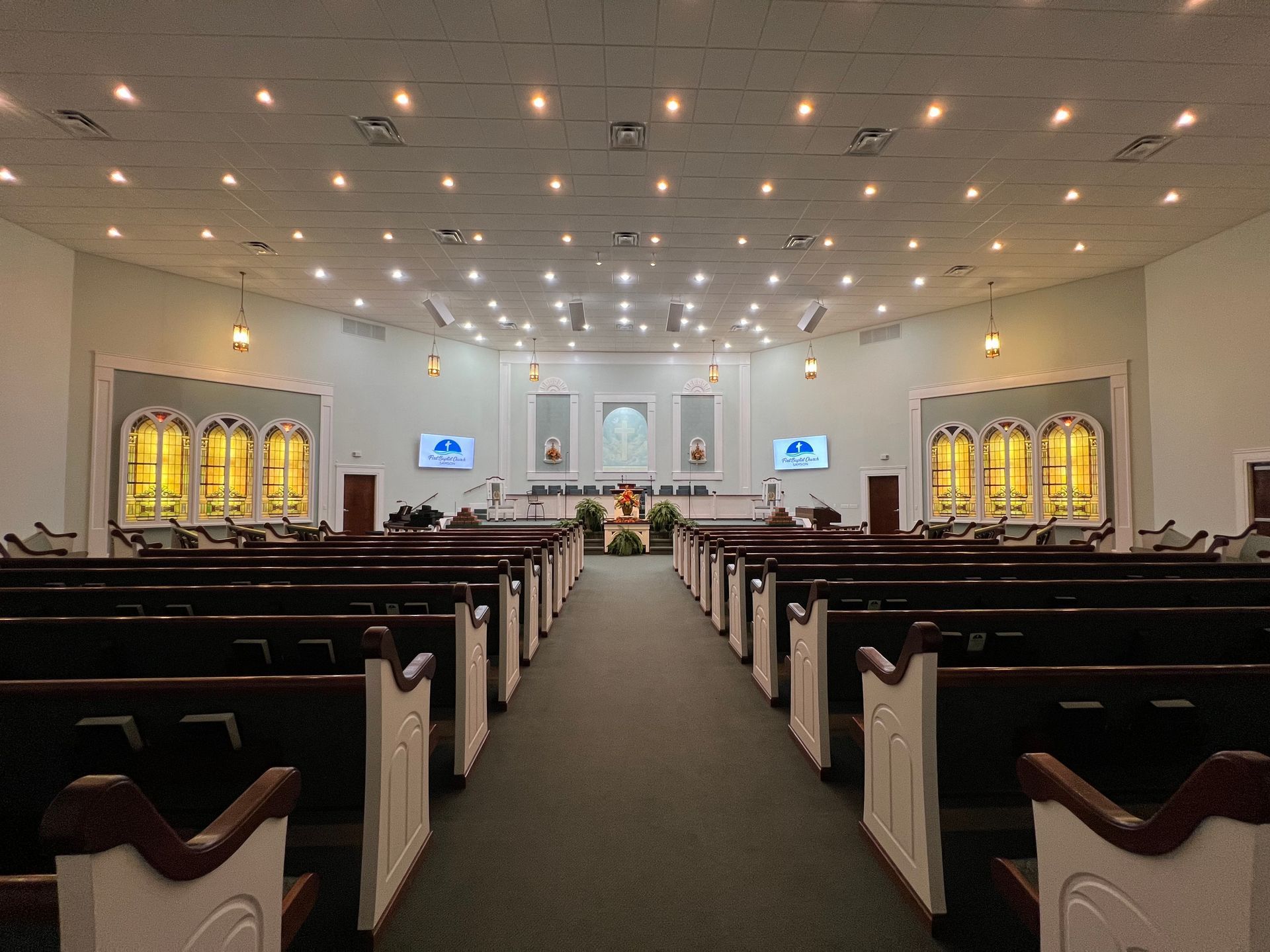 A church with rows of benches and a podium in the middle