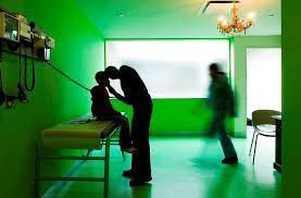 Doctor and patient in green exam room