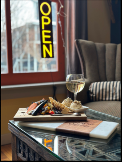 A cozy lounge at Chloe's with wine and a charcuterie platter
