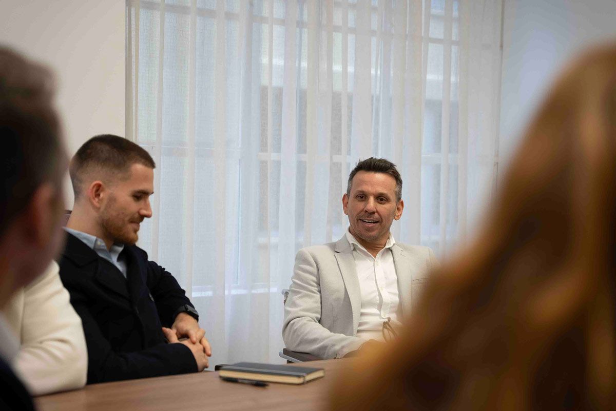 A group of Risk & compliance specialist recruiters are sitting around a table having a meeting