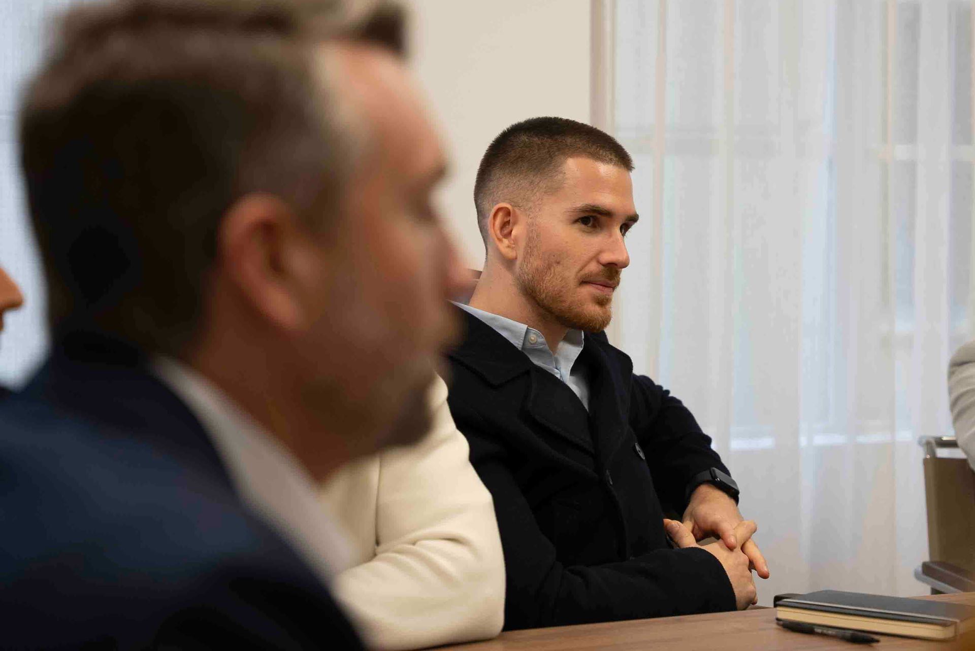 A group of Change management recruiters are sitting at a table having a meeting