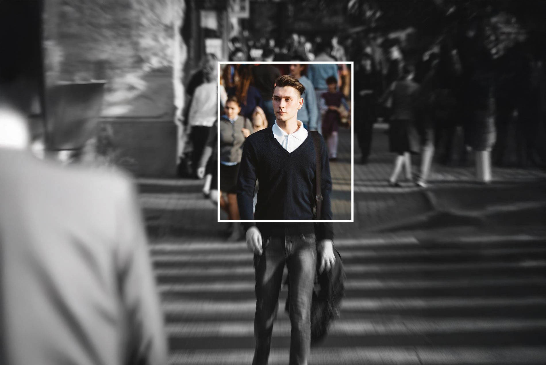 A employer is walking across a crowded street in a black and white photo