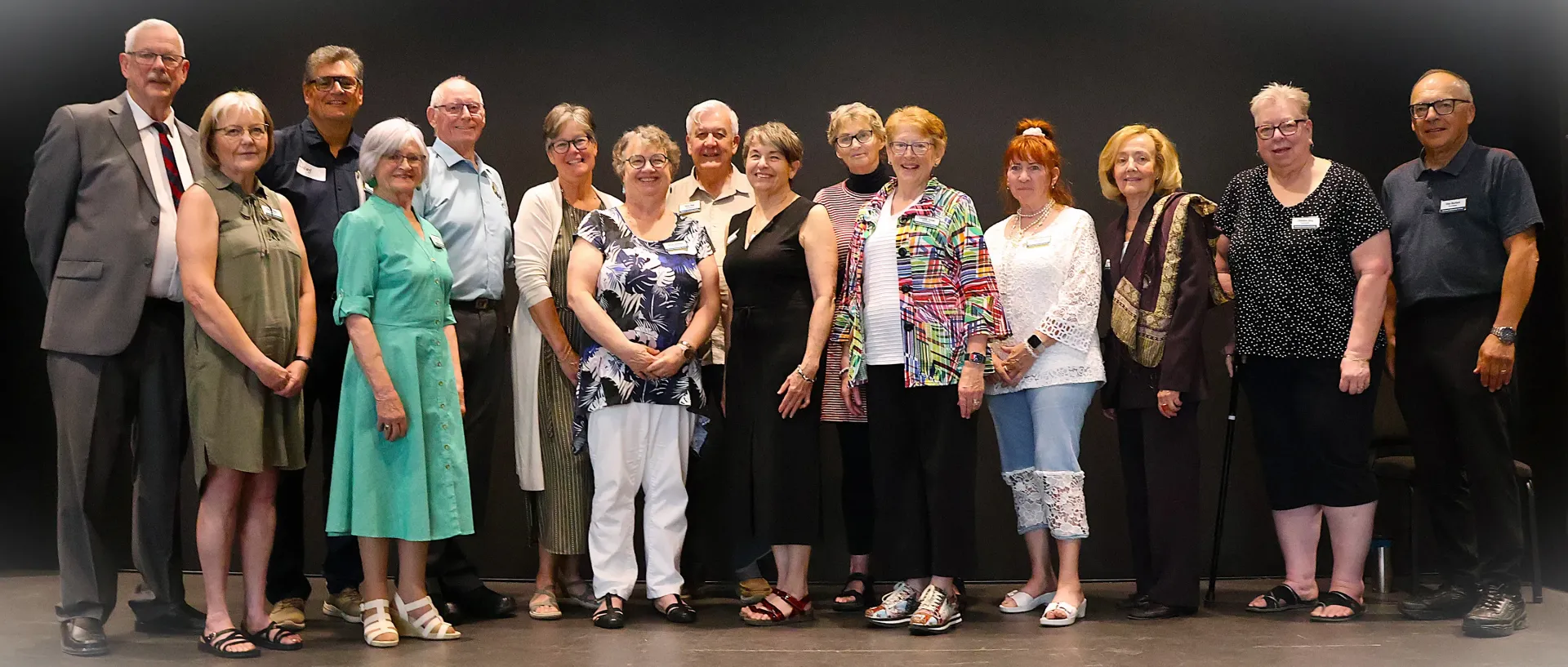 The SUG Board is posing for a picture in front of a building.