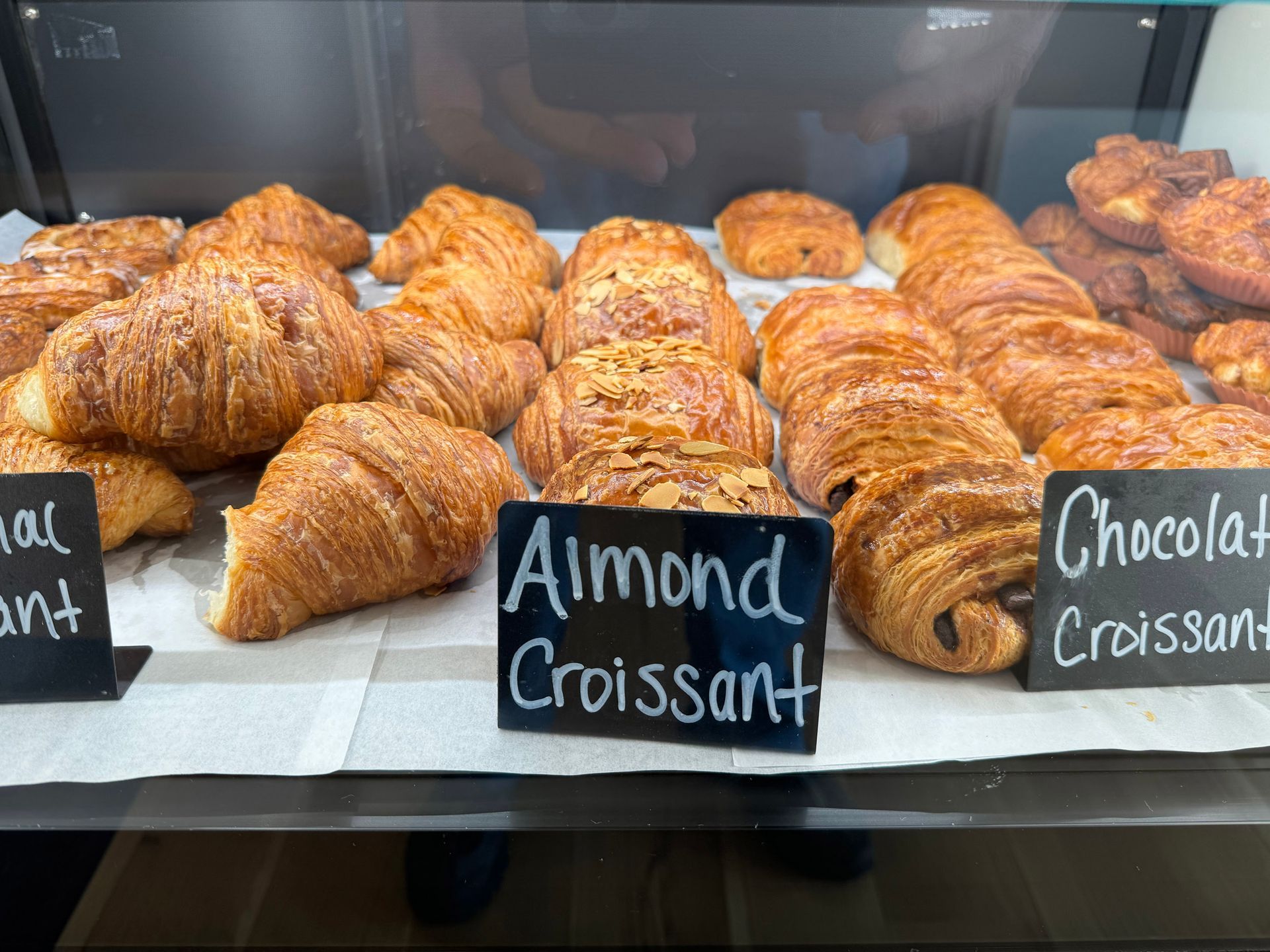 A display of almond croissants and chocolate croissants