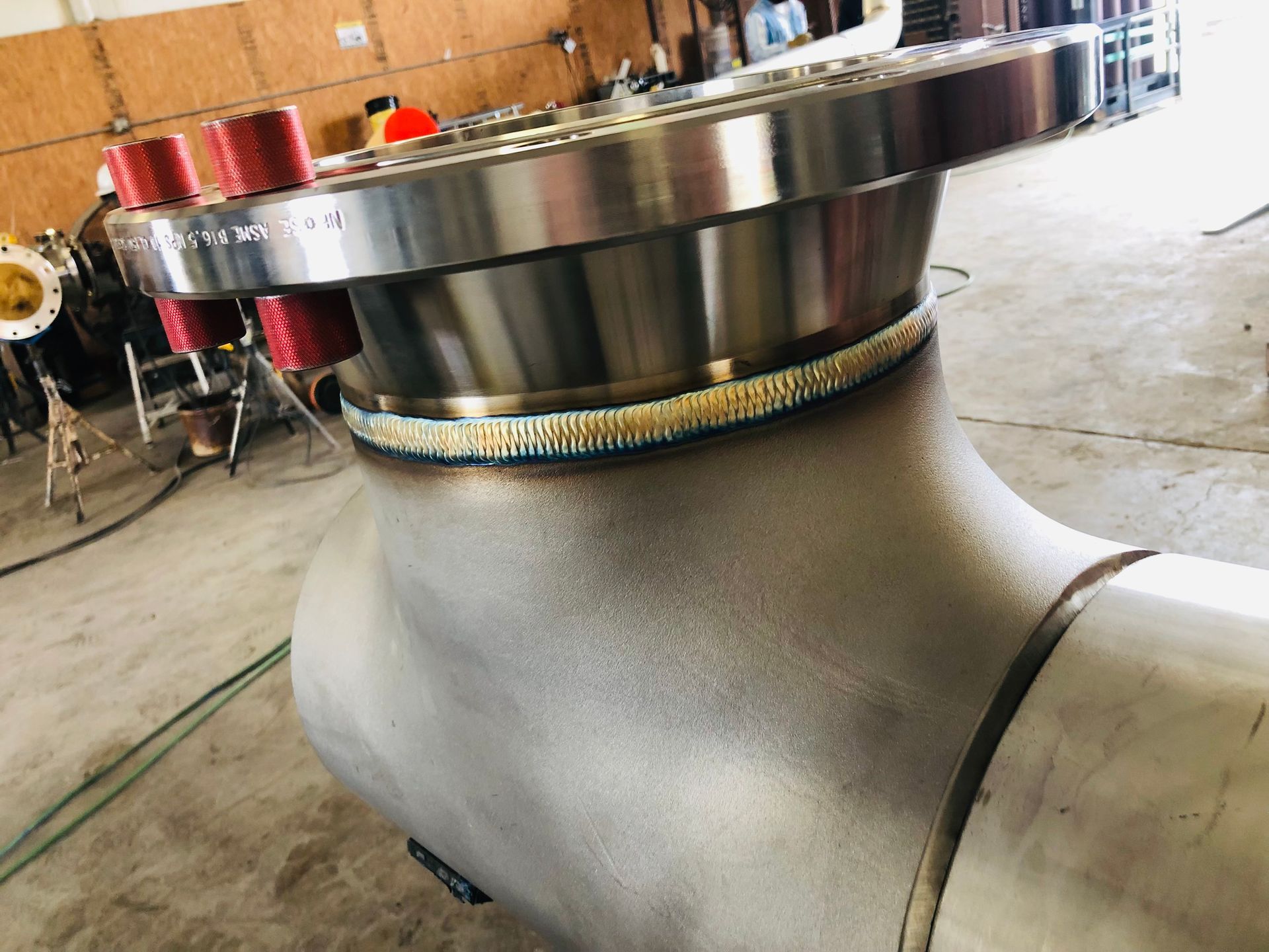 A stainless steel pipe with a flange on top of it