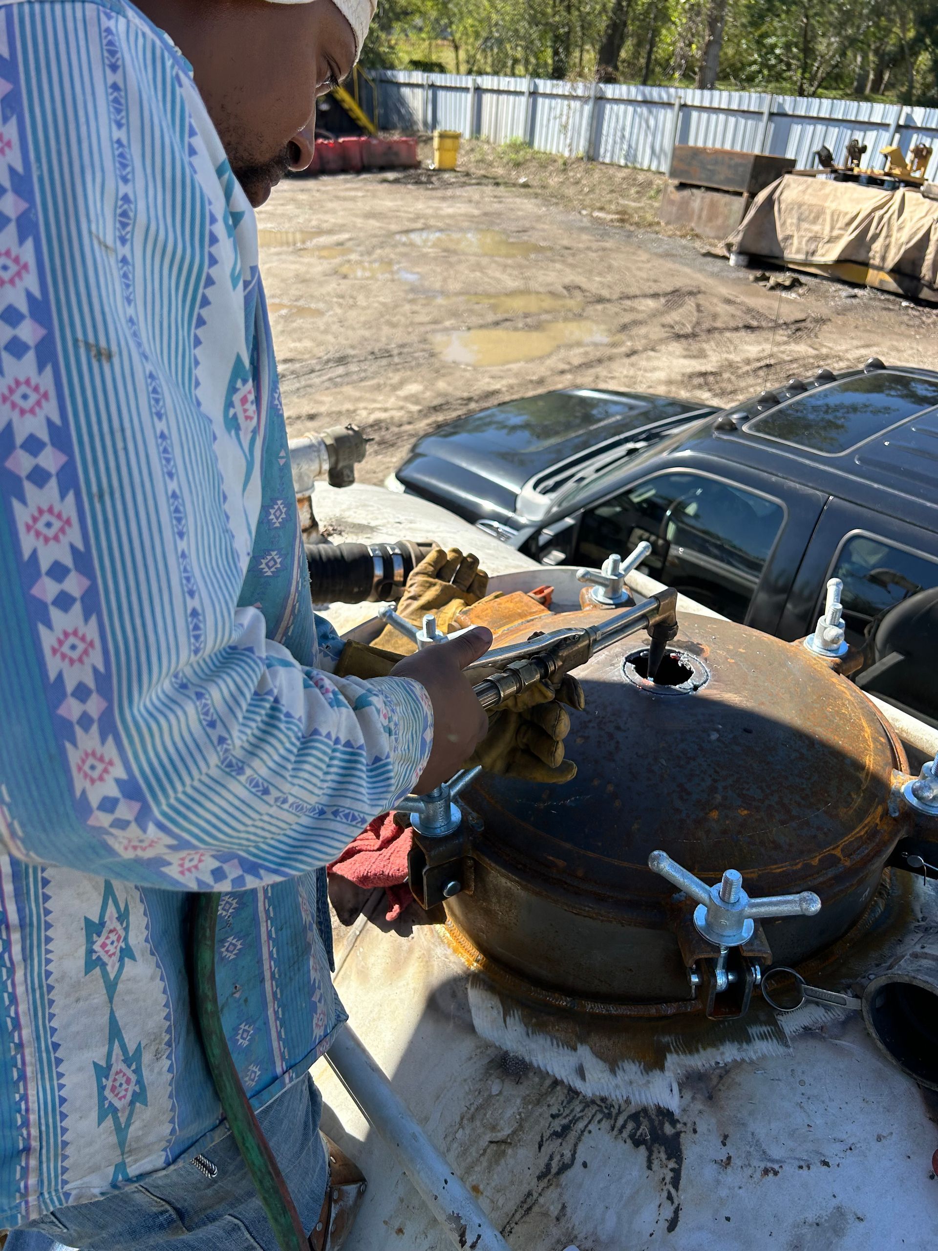 A man is standing next to a large tank of water.