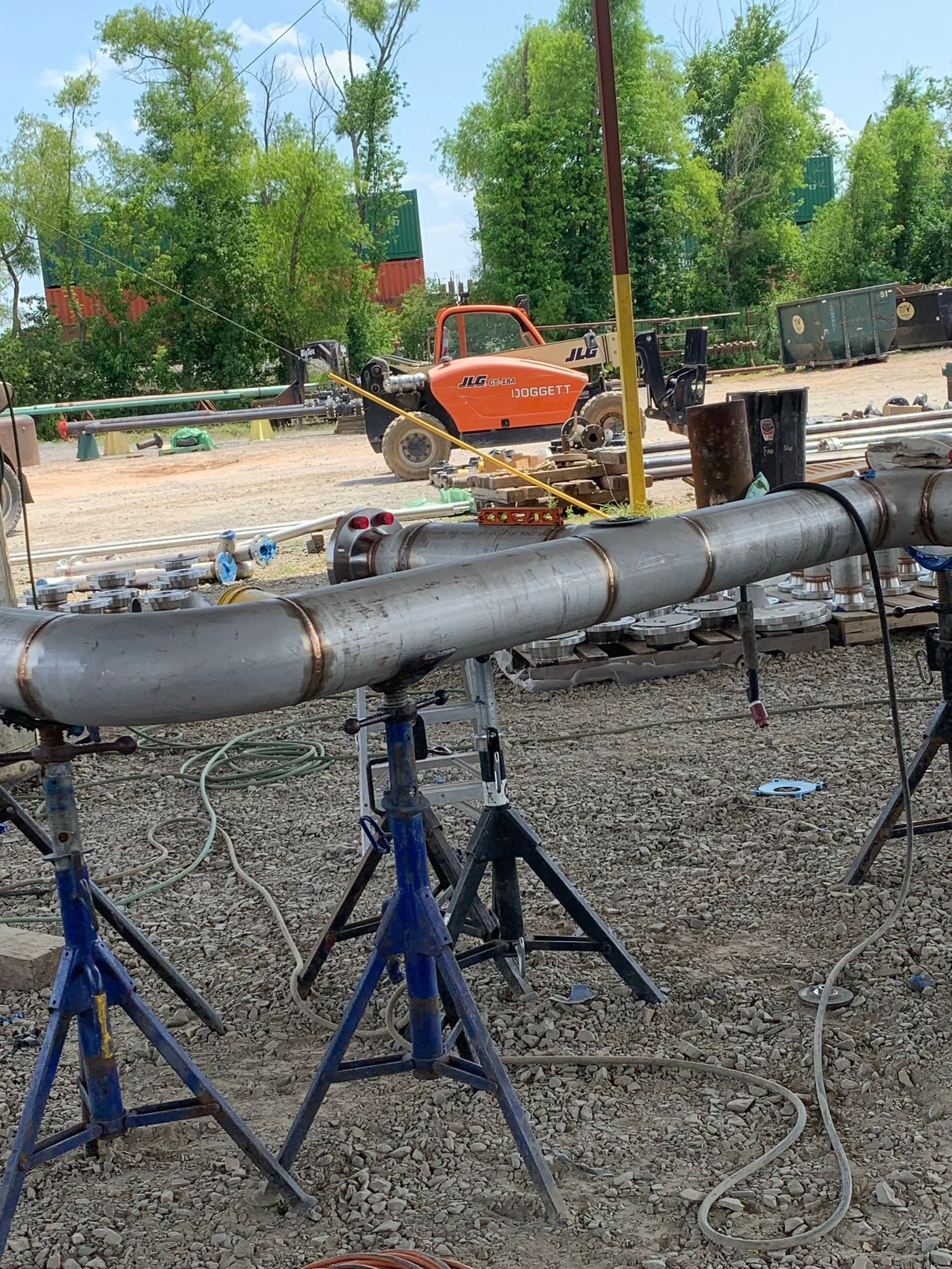 A large pipe is sitting on top of a pile of gravel on a construction site.