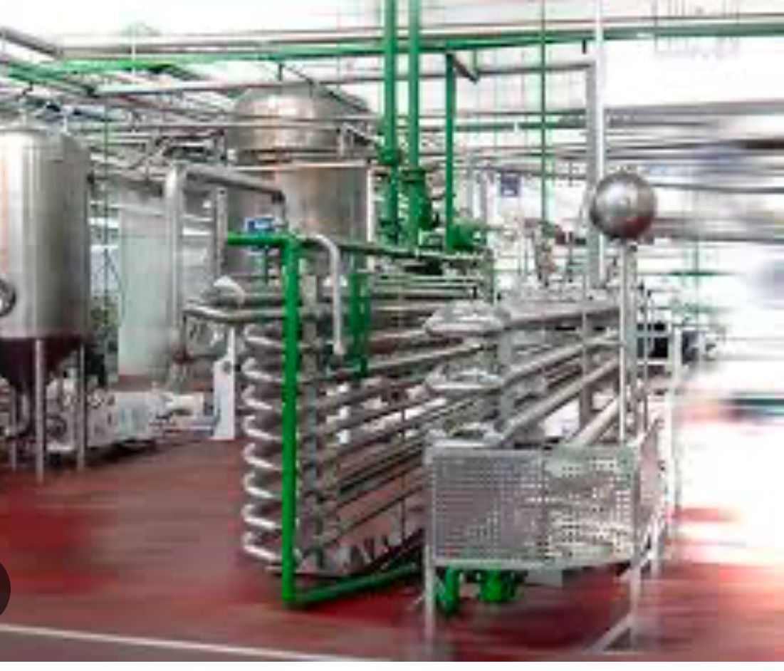 A factory filled with lots of pipes and machinery.