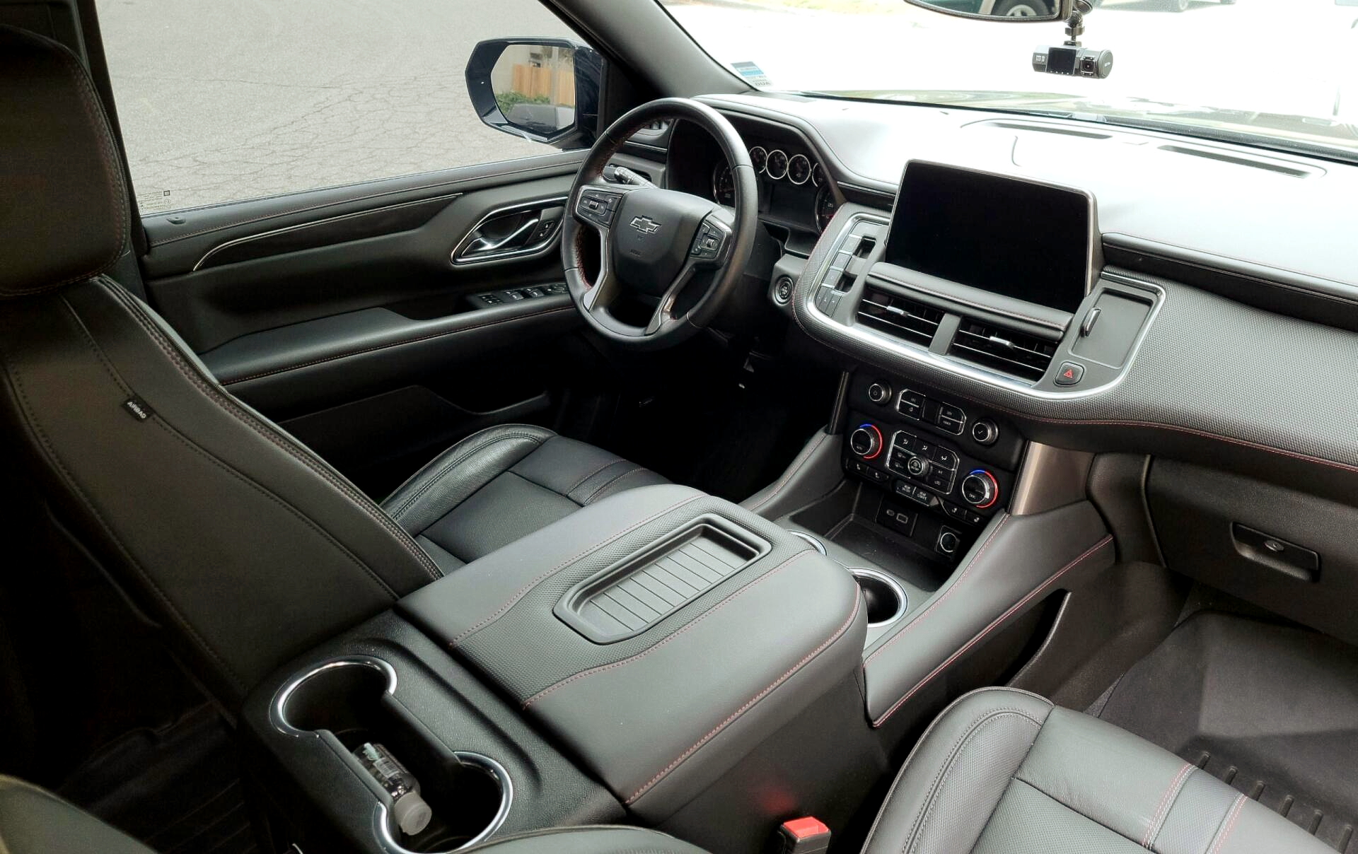the interior of a car with a steering wheel and a dashboard .