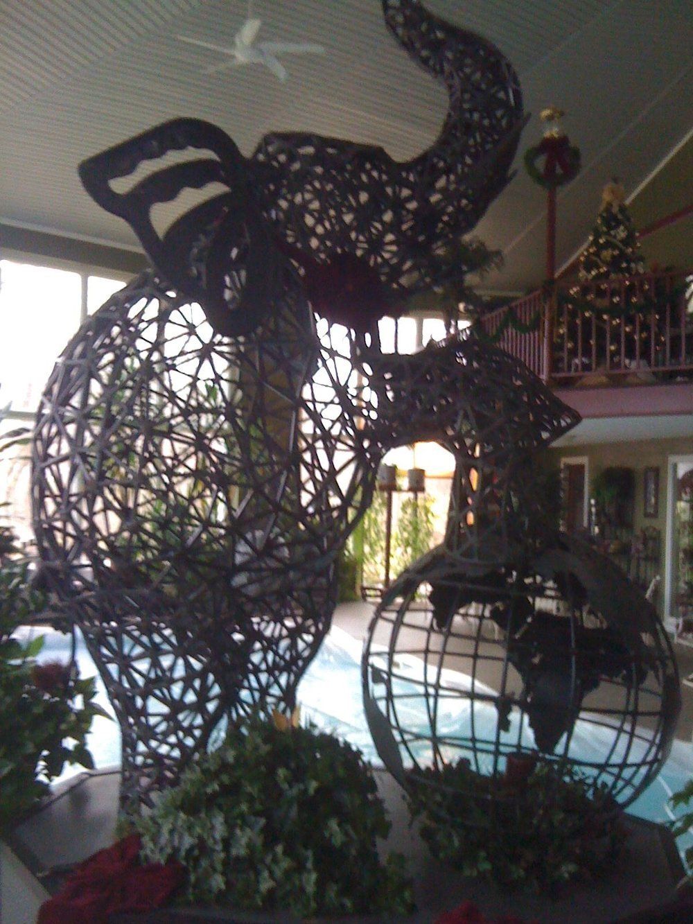 Decorative black metal sculpture with two animal figures in an indoor lobby