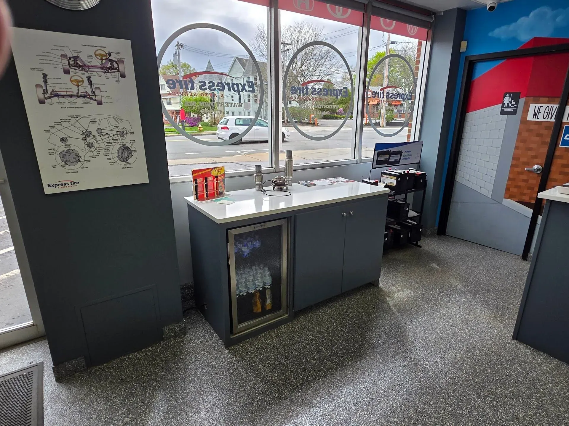 Bright Lobby with Counter, and Large Windows Showing Outdoor Signage | Express Tire & Auto Service