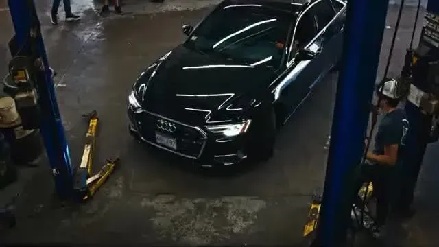 Black Sedan in an Auto Repair Shop | Express Tire & Auto Service