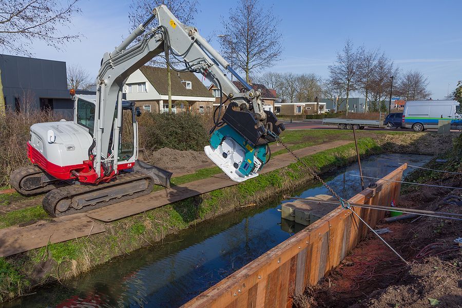 a crane is lifting a boat into the water