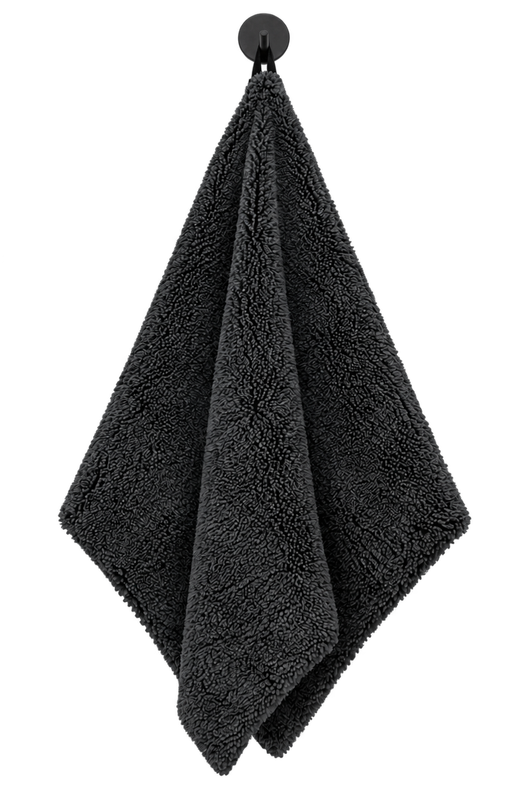 Dark gray textured towel hanging from a black wall hook