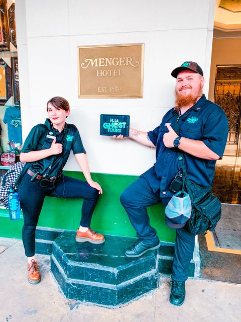 Two San Antonio Ghost Tour guides holding ipad in front of the Menger Hotel.