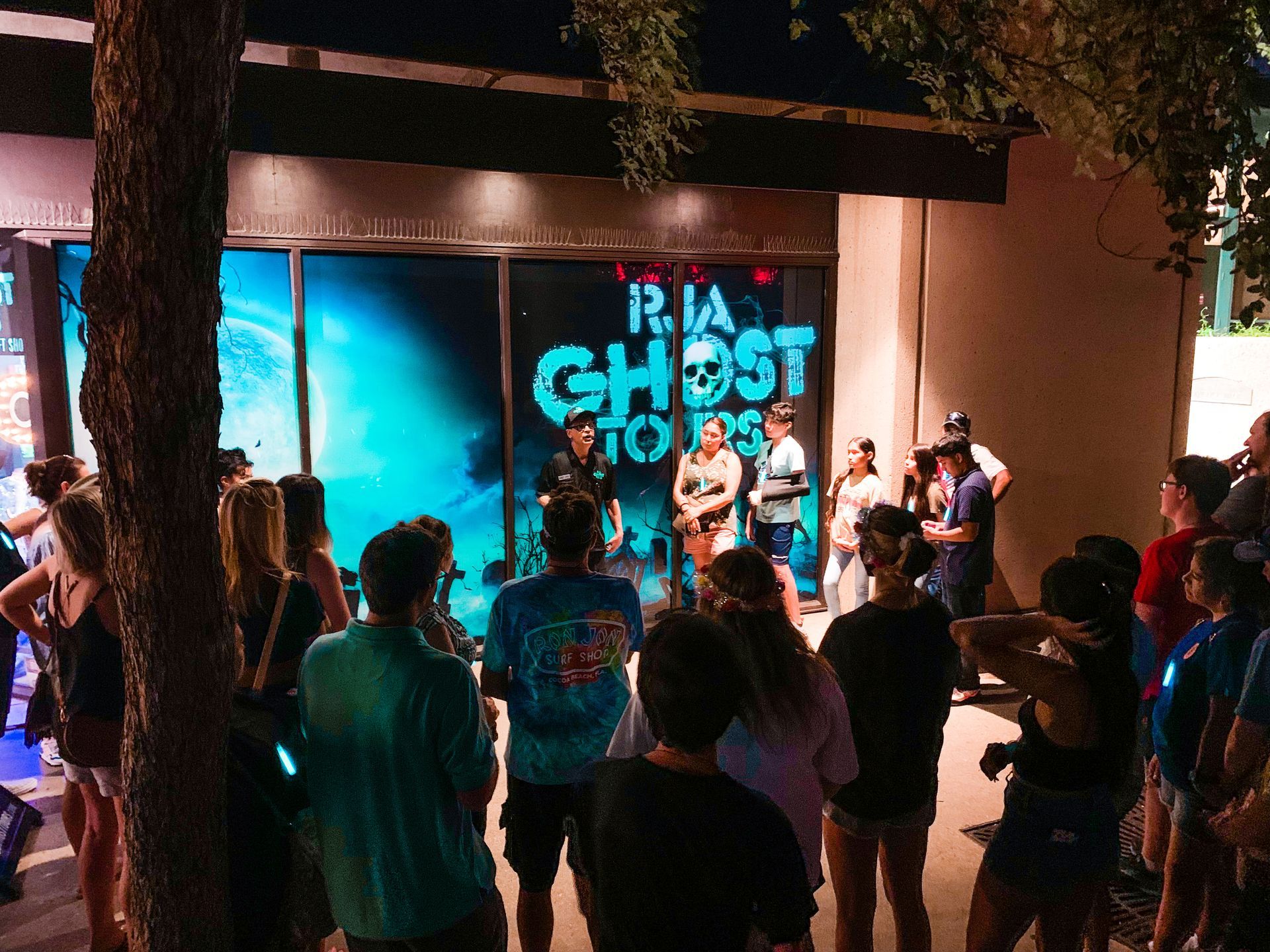 Ghost Tour standing in front of a RJA GHOST TOURS gift shop. 