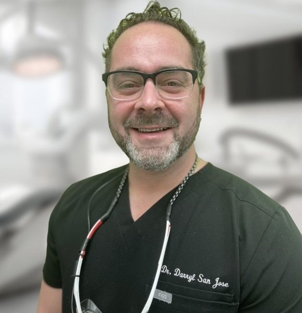 A man wearing glasses and a black shirt that says dr. danyll san jose