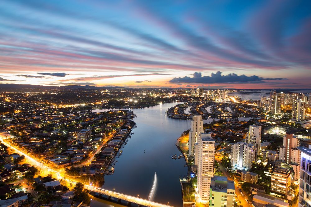 An Aerial View Of A City At Night With A River Running Through It — Hutchisons Tile Centre In Gold Coast, QLD