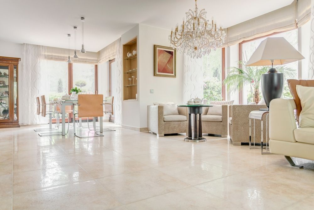 A Living Room With A Couch, Chairs, A Table And A Chandelier — Hutchisons Tile Centre In Kingscliff, NSW