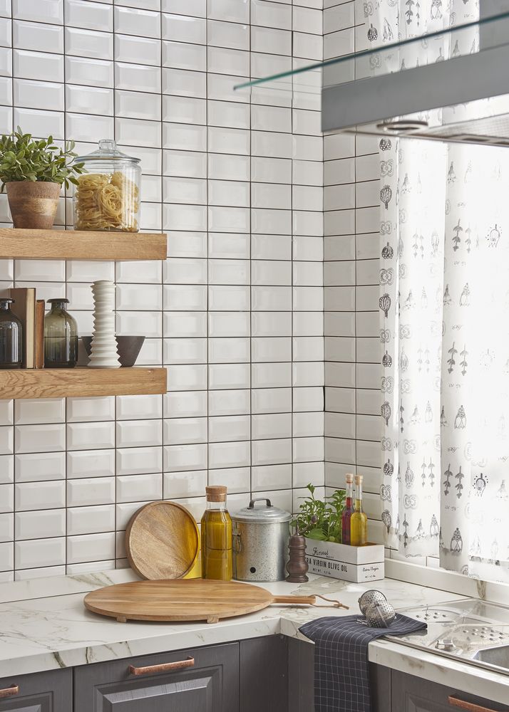 A Kitchen With White Tiles, Wooden Shelves, A Sink, And A Window — Hutchisons Tile Centre In Kingscliff, NSW