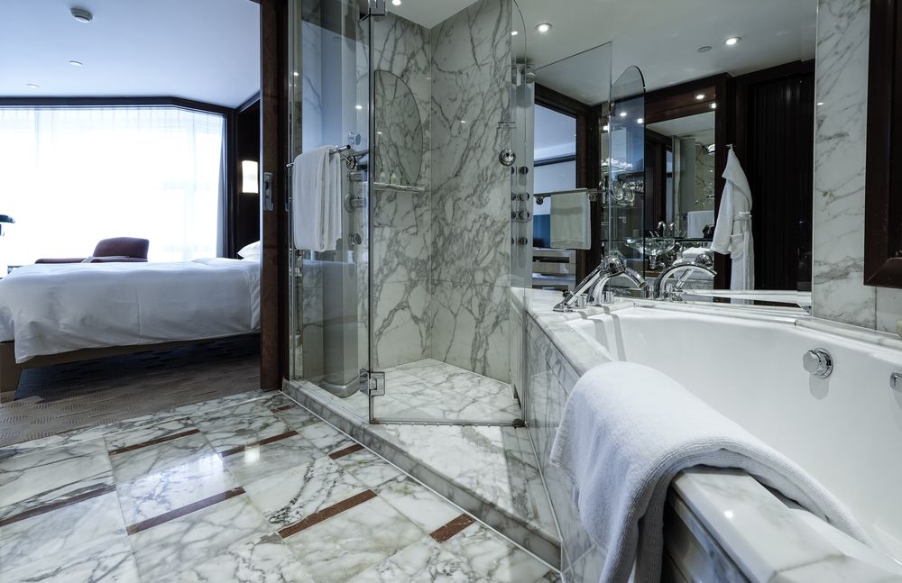A Bathroom In A Hotel Room With A Bathtub And A Walk In Shower — Hutchisons Tile Centre In Tweed Heads, NSW
