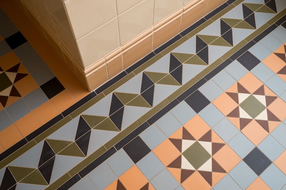 A Tiled Floor With A Geometric Pattern On It — Hutchisons Tile Centre In Byron Bay, NSW 