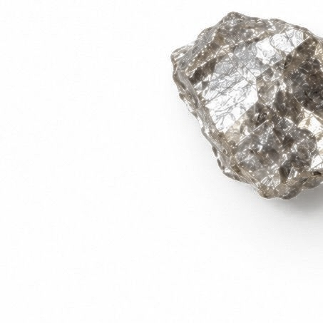 Rough gray crystal or mineral specimen on a white background